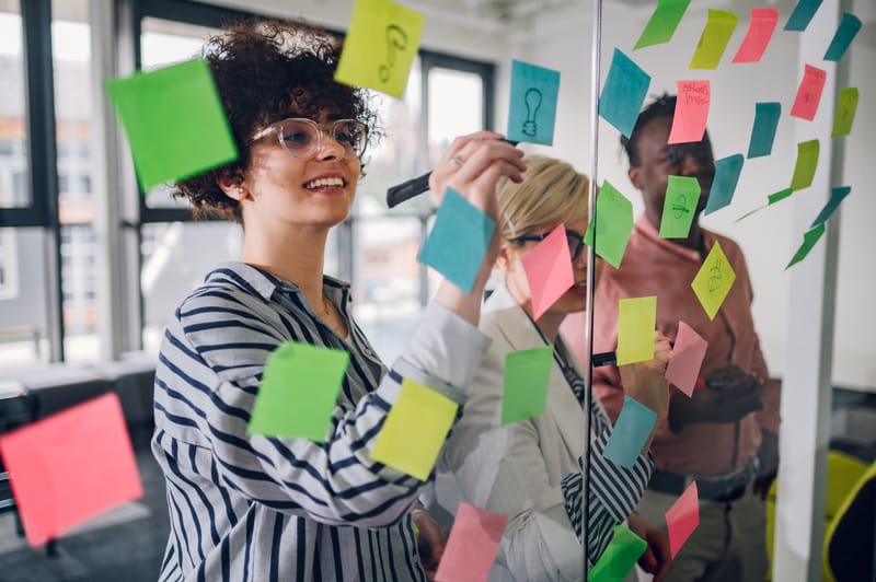 team writes on sticky notes